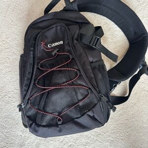 New, never used. Canon Camera Black Sling Bag.